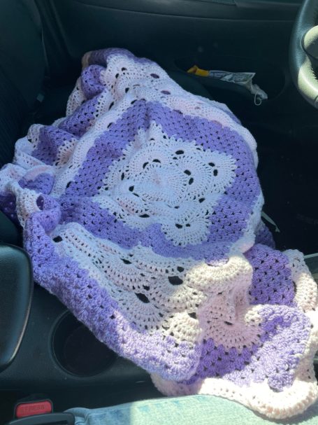 Pink and purple crocheted baby blanket.